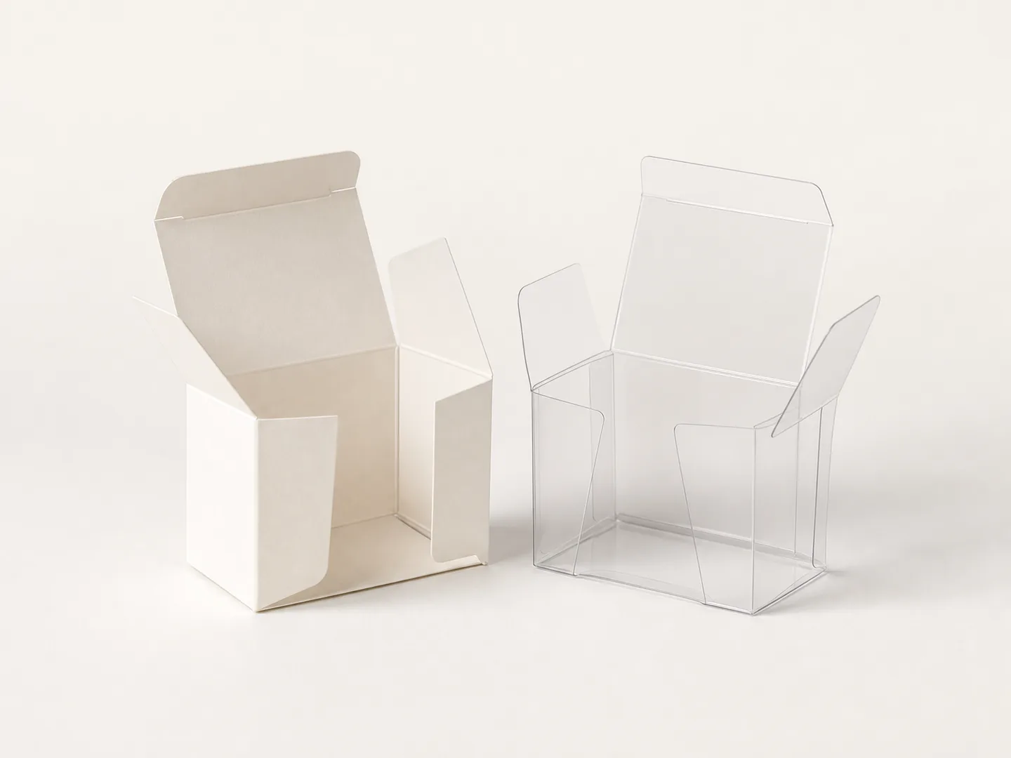 Illustrative unbranded paperboard and clear folding-material forms presented with equal emphasis; final material choice requires project confirmation.